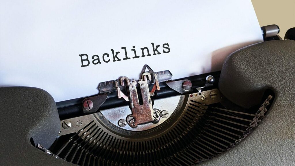 A typewriter typing the word "Backlinks" on a sheet of bond paper. 